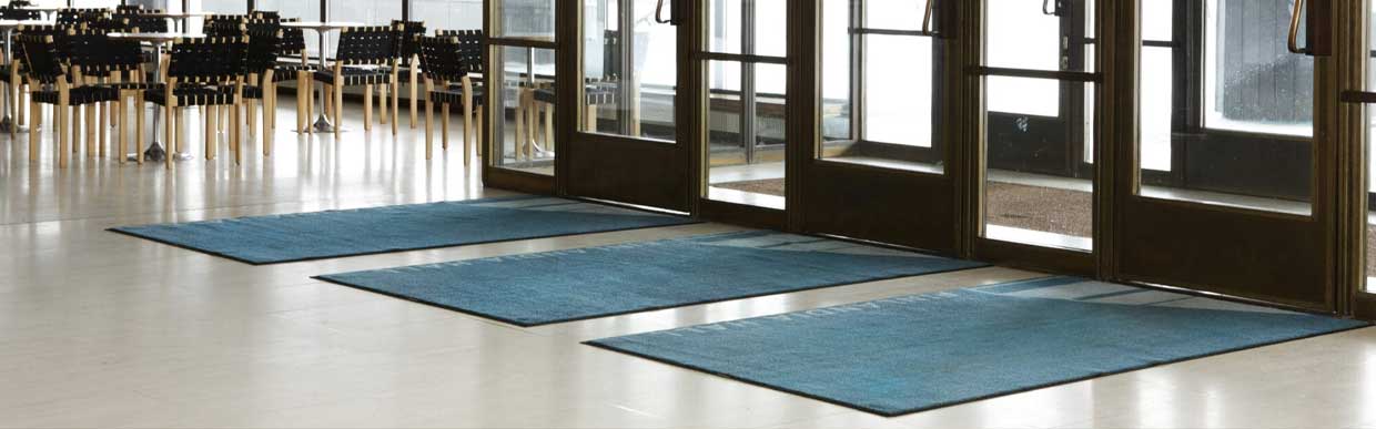 Wide view of industrial warehouse with high-traffic safety flooring and anti-fatigue mats installed by {siteName} in the UK